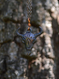 Copper-coated buff skull pendant